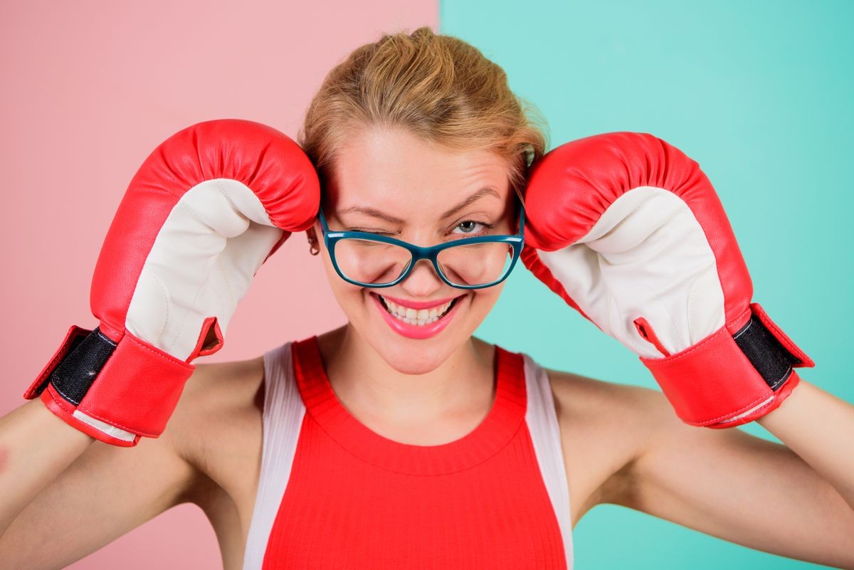 Woman boxing gloves adjust eyeglasses. Win with strength or intellect. Strong intellect victory pledge. Know how defend myself. Confident her power. Strong mentally and physically. Smart and strong.